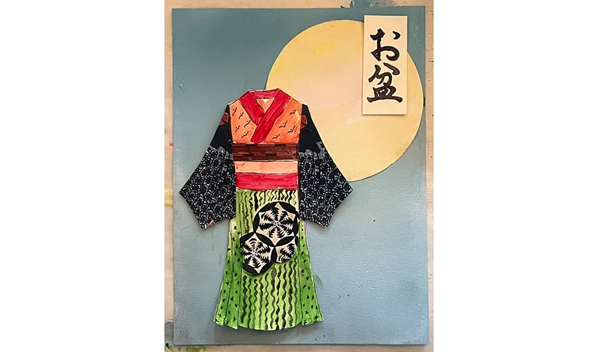 photo of arts and crafts work on paper featuring a Japanese style dress against a blue background with a yellow moon and Japanese characters in the top right